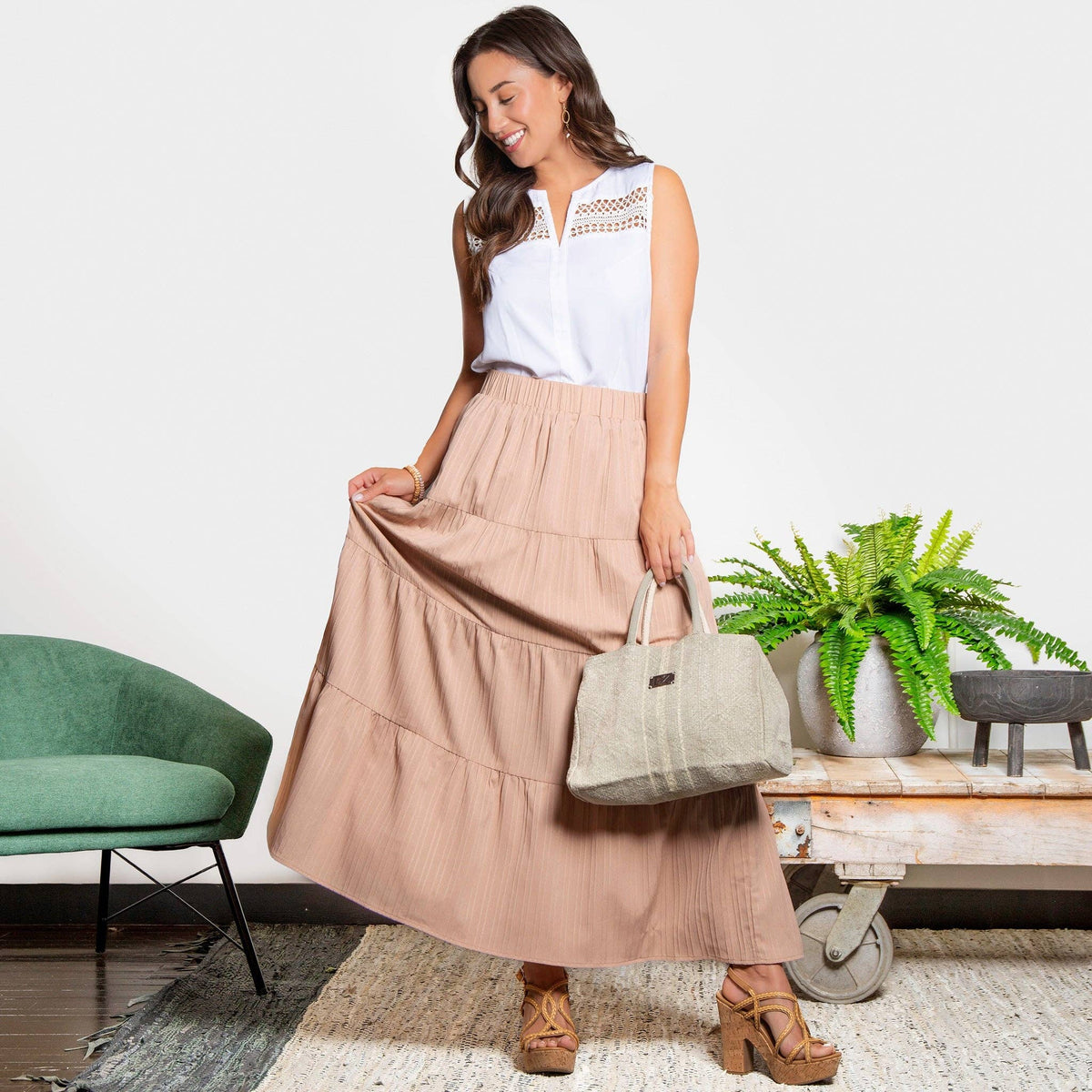 Howard's McKay tiered rosewater maxi skirt with pockets, flowing fabric, and a comfortable waistband, styled with a casual top.