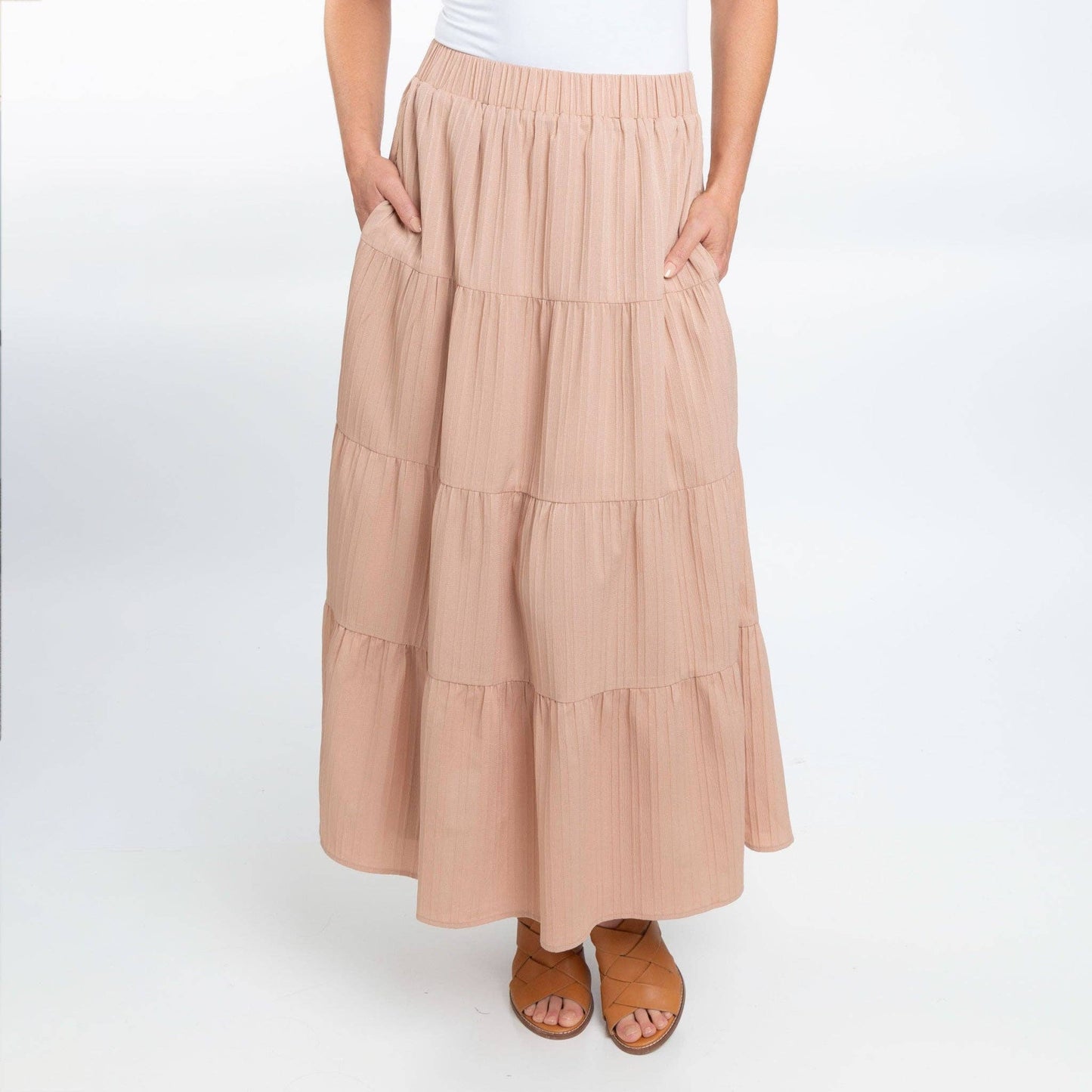 Howard's McKay tiered rosewater maxi skirt with pockets, featuring a flowy design and vibrant floral pattern.