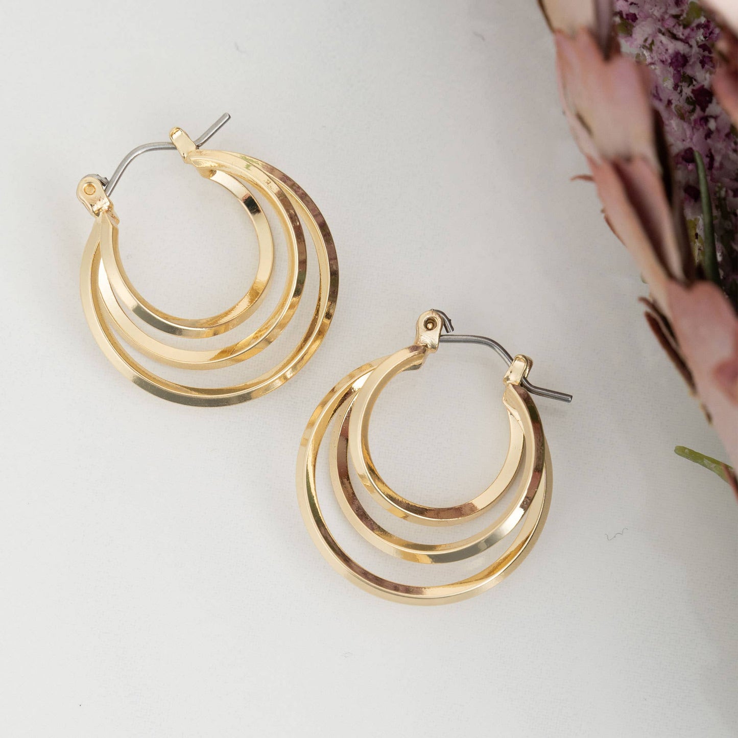 Nickel-free classic hoop earrings by Howard's, showcasing sleek, silver-toned hoops against a neutral background.