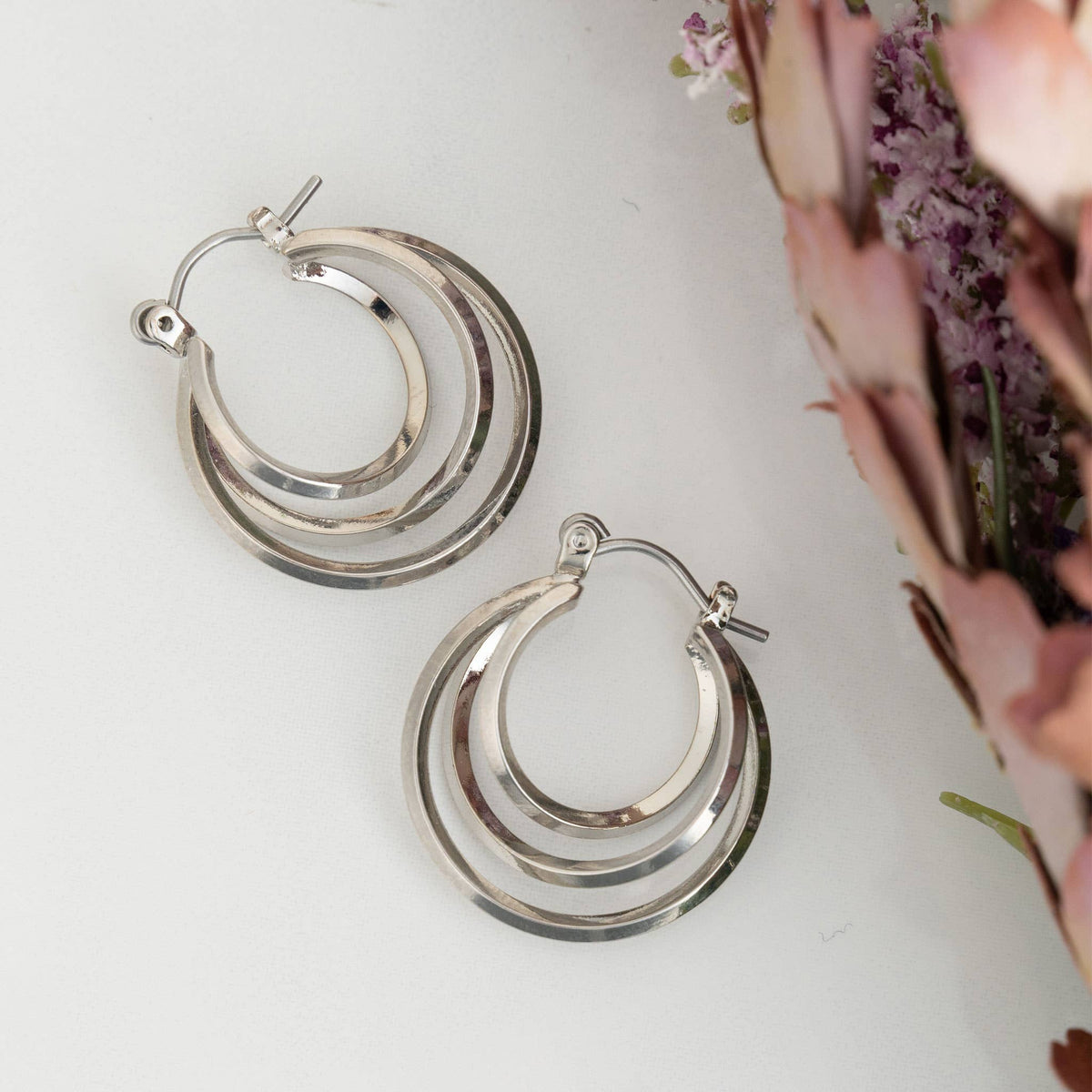 Nickel-free classic hoop earrings by Howard's, shown in a close-up image highlighting their smooth, circular design.