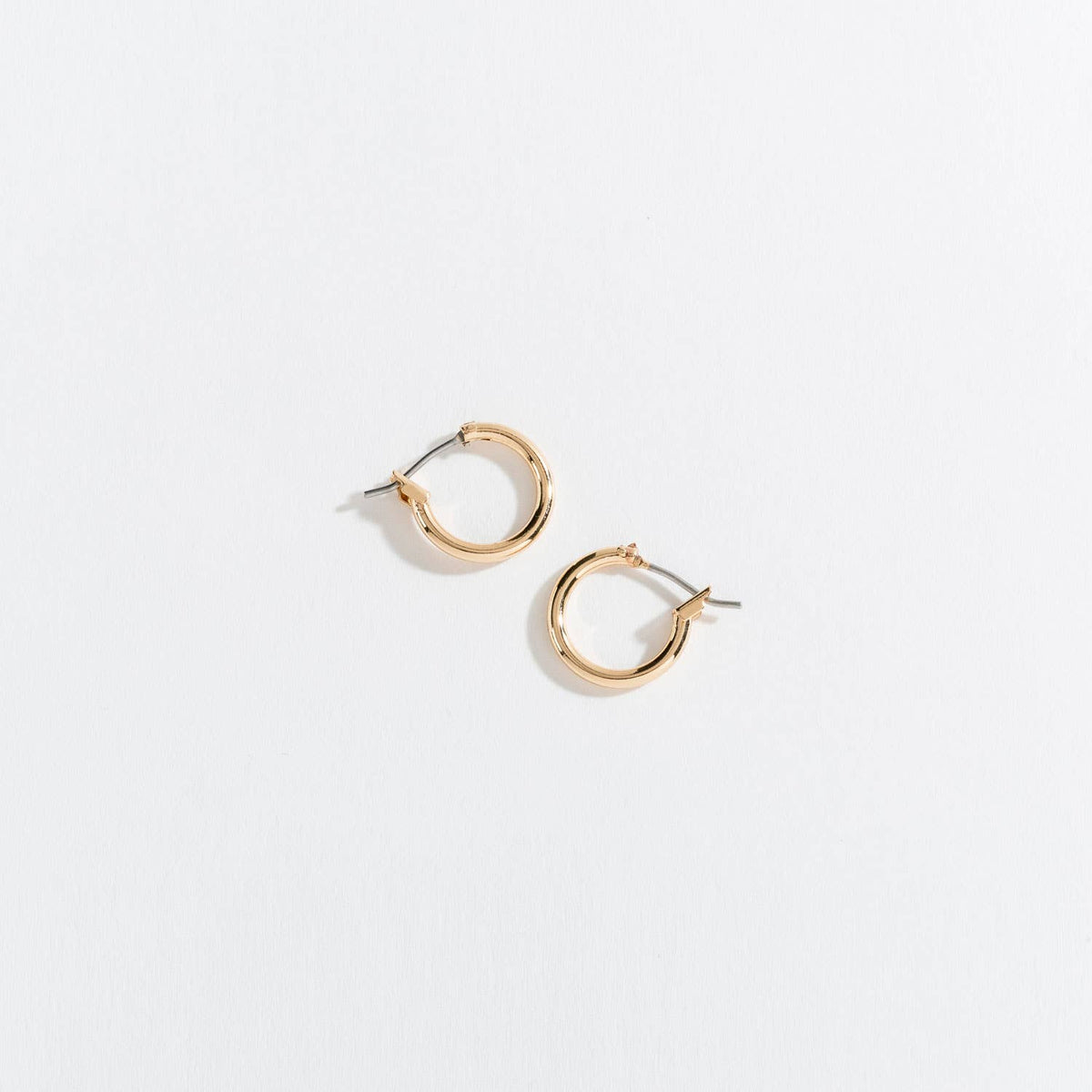 Howard's Ear Sense Click Hoop Earrings showing gold-tone hoops with secure click clasps on a white background.