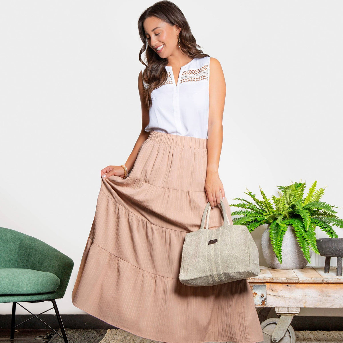 Howard's white sleeveless V-neck tank top blouse with a fitted design and smooth fabric, perfect for casual or layered looks.