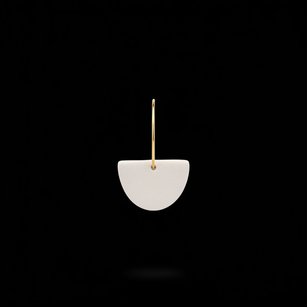 Jax Kelley clay half moon sculpture in oat milk color, featuring smooth curves and a matte finish on a neutral background.