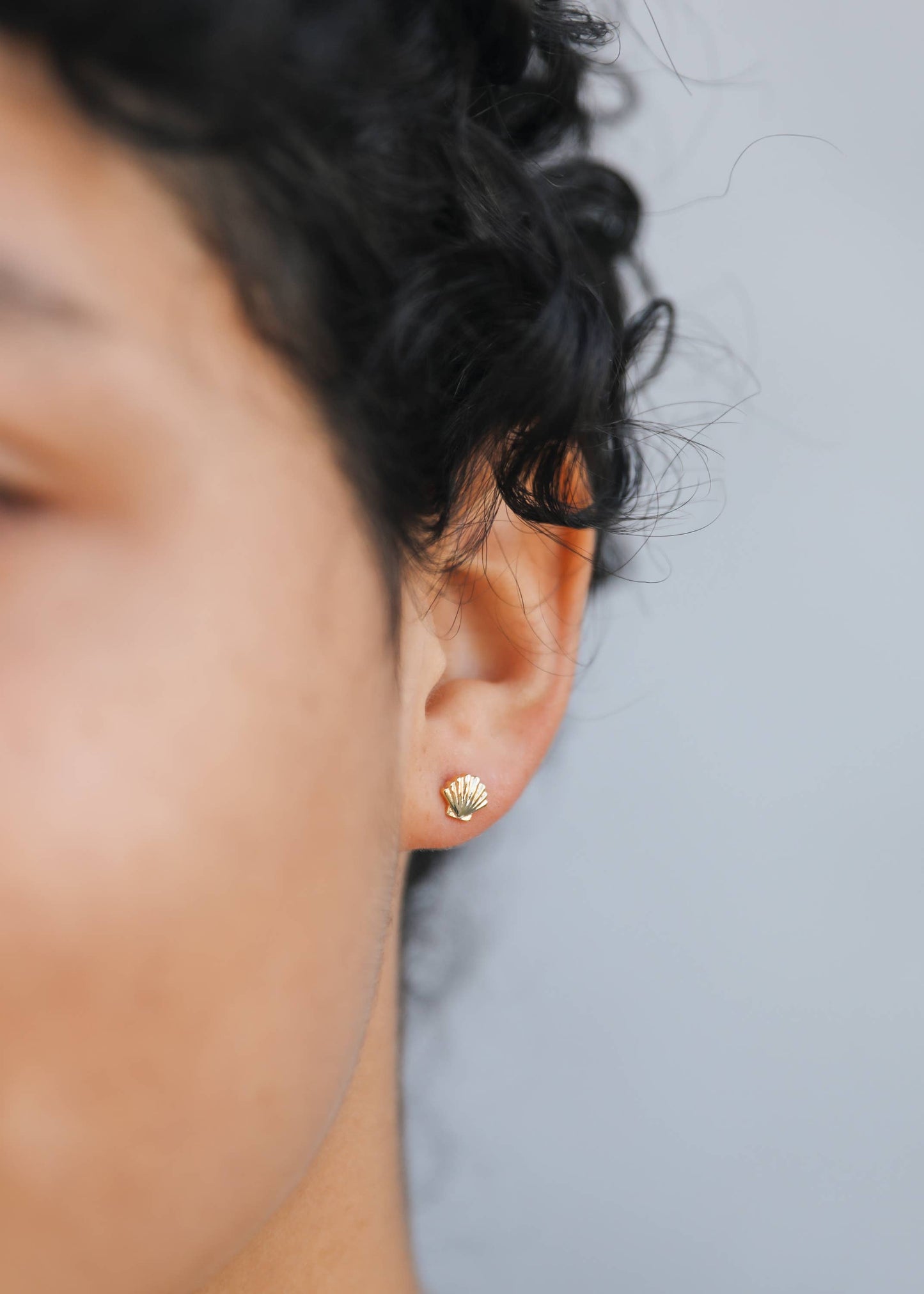 Gold seashell earrings by Jax Kelley featuring delicate seashell design and shiny gold finish.