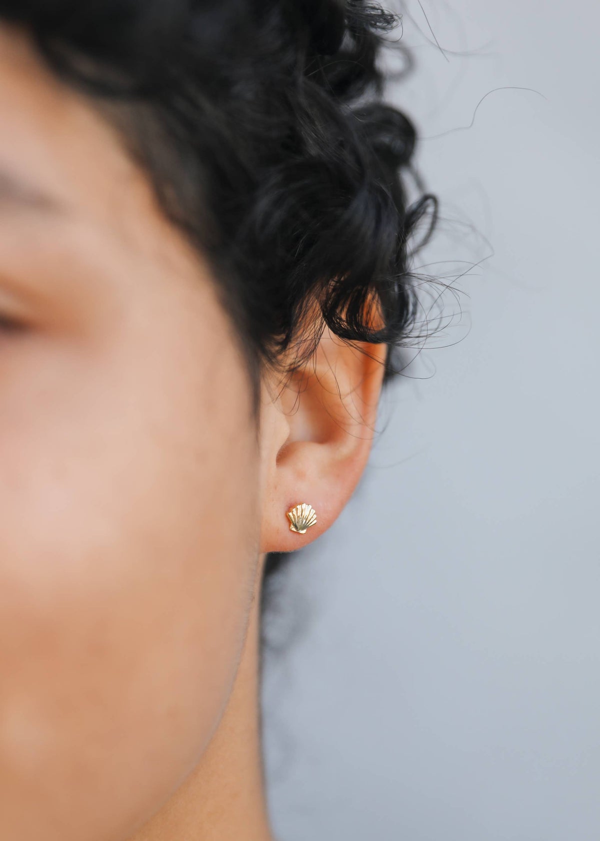 Gold seashell earrings by Jax Kelley featuring delicate seashell design and shiny gold finish.