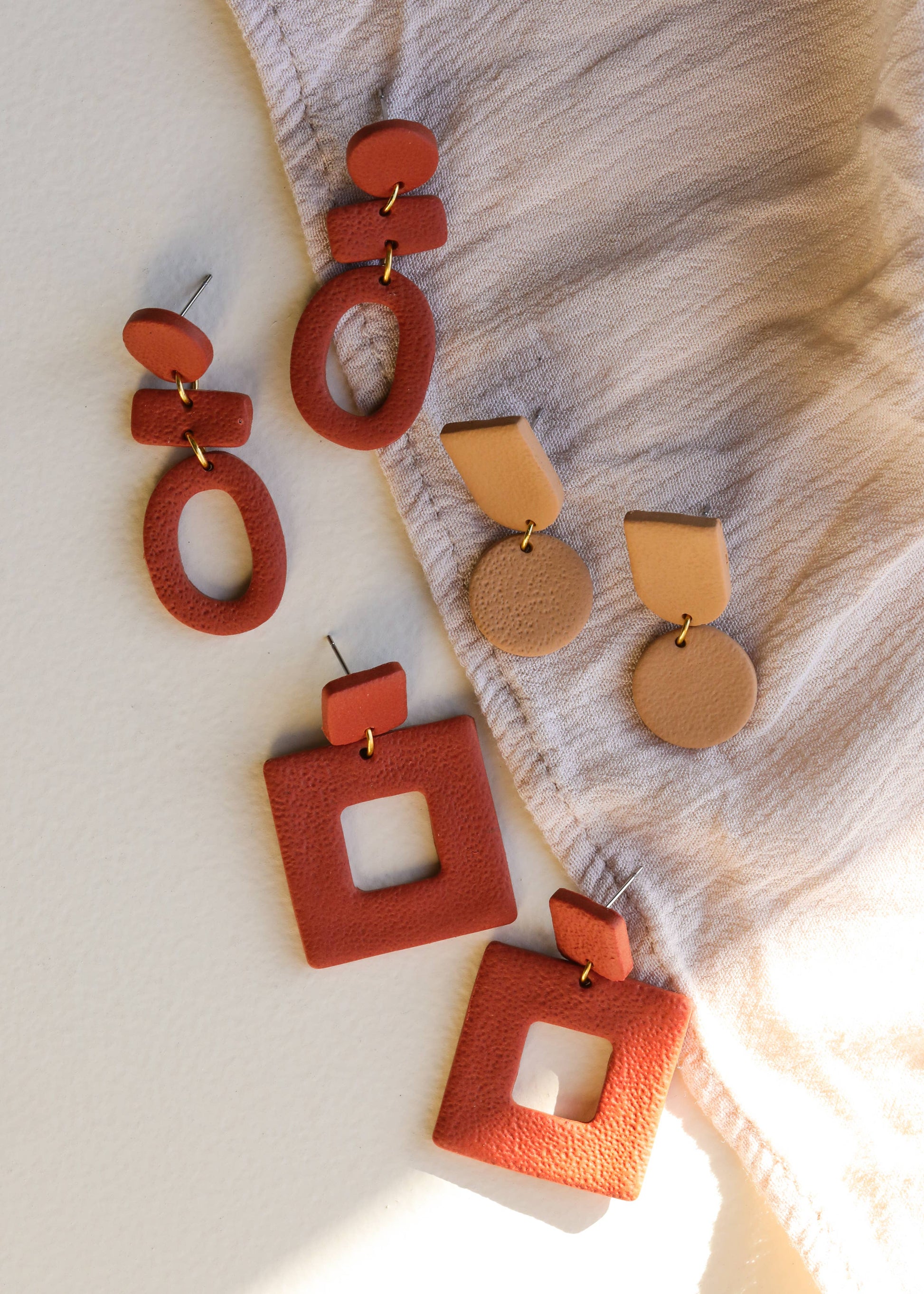 Square terracotta clay earrings by Jax Kelley featuring a natural, earthy design perfect for boho or casual styles.