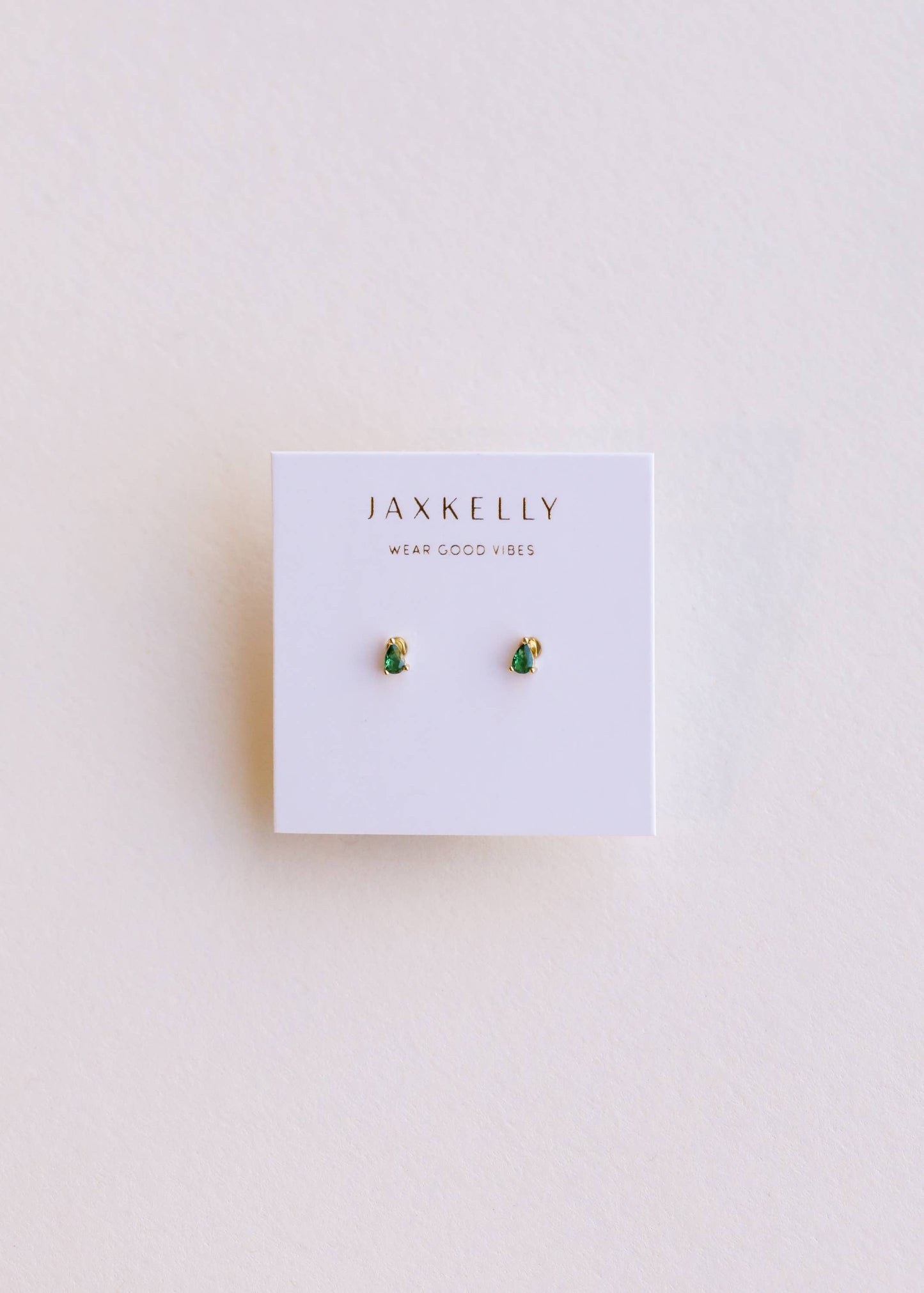 Jax Kelley teardrop earrings with emerald cubic zirconia gemstones, featuring a sleek, elegant design for stylish wear.