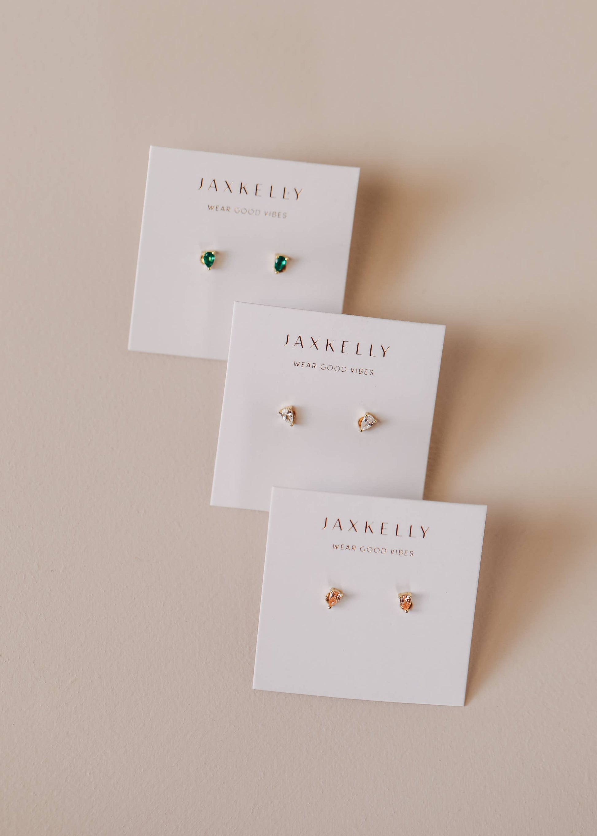 Jax Kelley Teardrop Emerald CZ earrings featuring dangling teardrop-shaped green cubic zirconia jewelry.