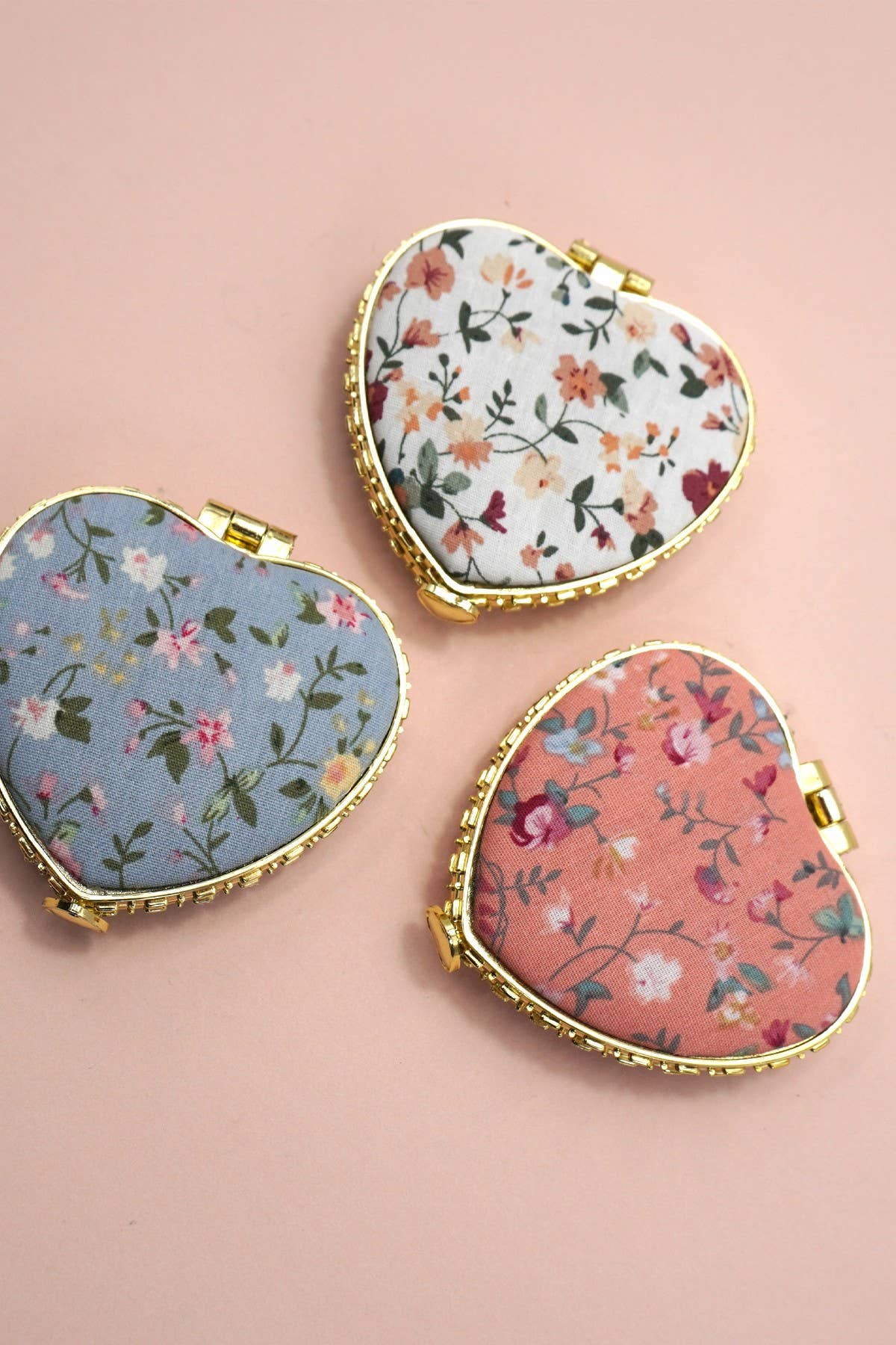 JOSSLYN travel pocket compact handheld floral mirror with a decorative floral design on the cover, perfect for on-the-go use.