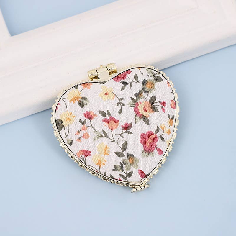JOSSLYN travel pocket compact handheld floral mirror with a floral design and foldable cover, perfect for on-the-go use.