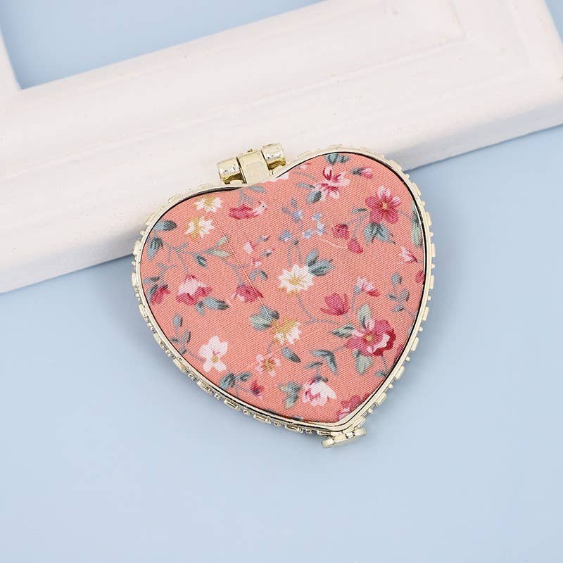 JOSSLYN travel pocket compact handheld floral mirror with a decorative floral design and foldable cover.