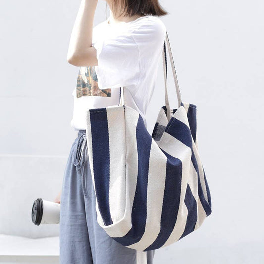 JOSSLYN by wall to wall striped tote bag with bold horizontal black and white stripes, featuring sturdy handles and spacious interior.