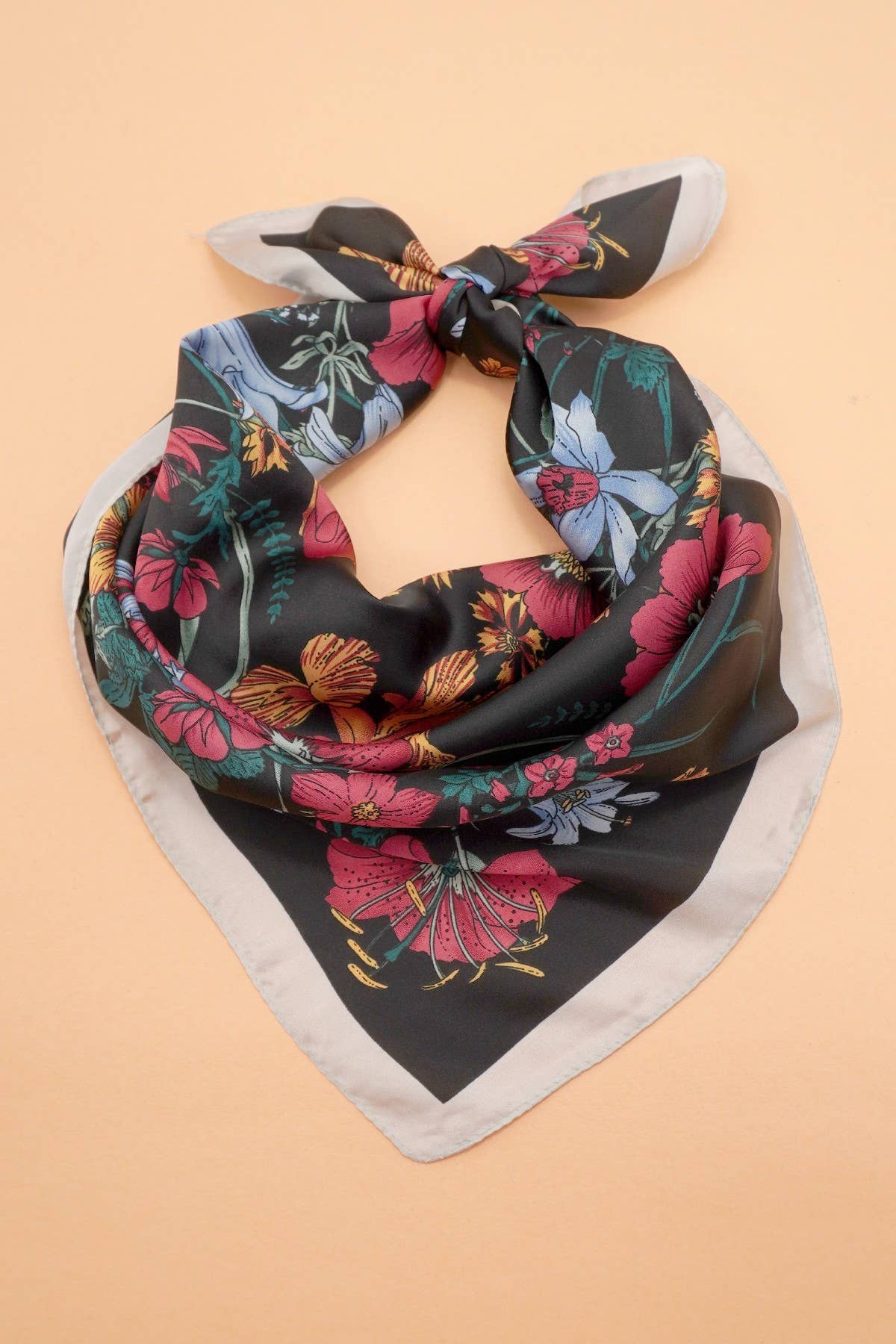 Large floral print bandana scarf by JOSSLYN, featuring vibrant floral design and lightweight fabric, perfect for styling accessories.