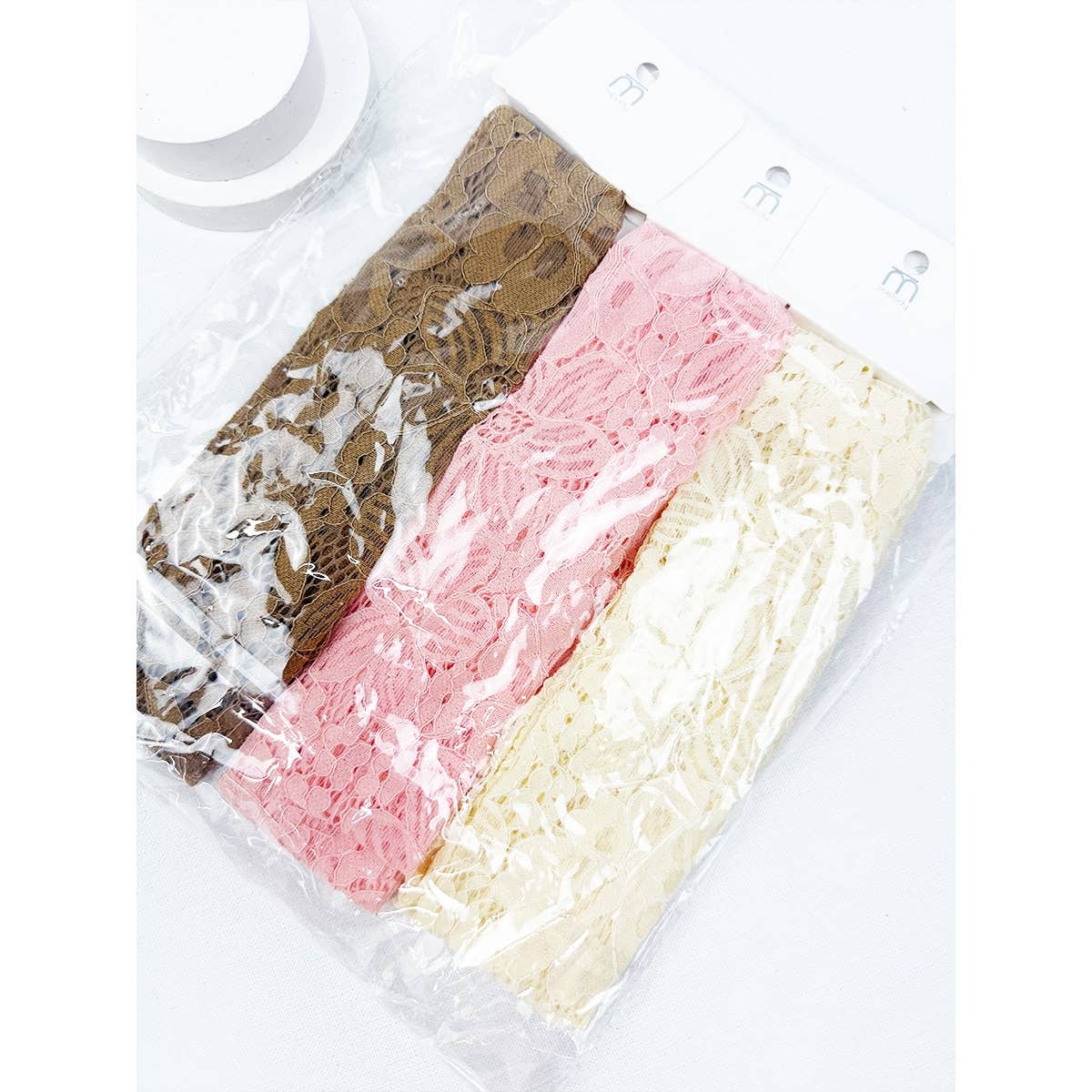 Stretch lace headwrap by Love and Repeat, a stylish hair accessory featuring soft, elastic lace fabric for a comfortable fit.