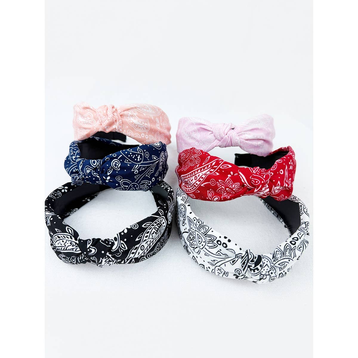 Love and Repeat bandana knot hairband featuring a stylish fabric design, perfect for adding a trendy touch to hair styling.