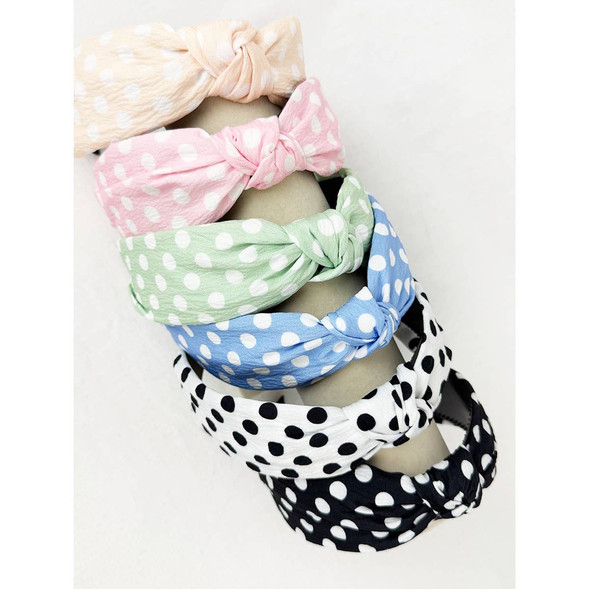 Polkadot print knot hairband by Love and Repeat featuring a black and white polka dot pattern on soft fabric.