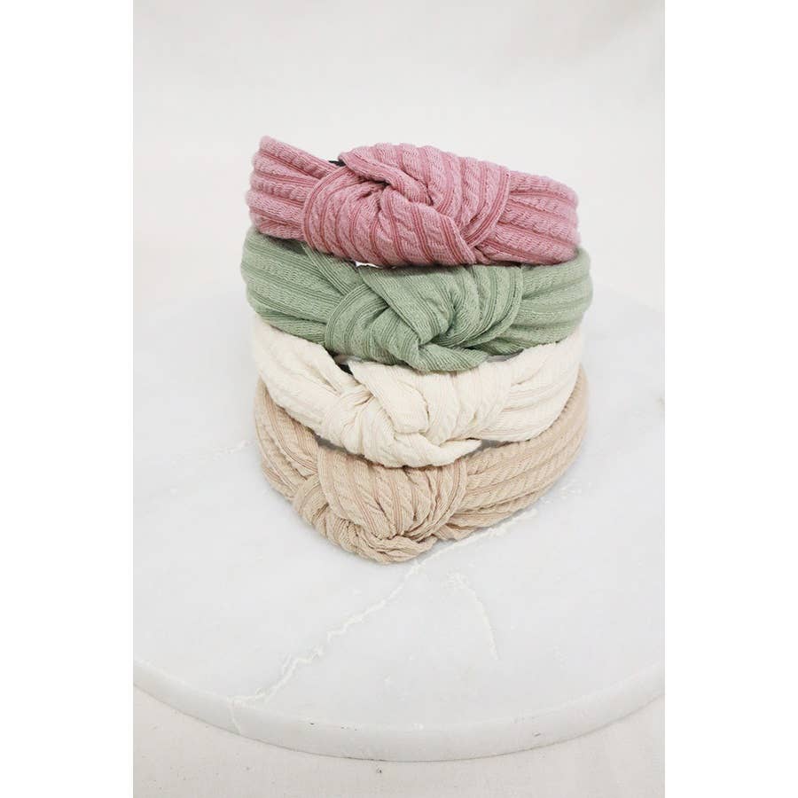 Ribbed knotted headband from Love and Repeat, featuring a textured fabric and stylish knot detail.
