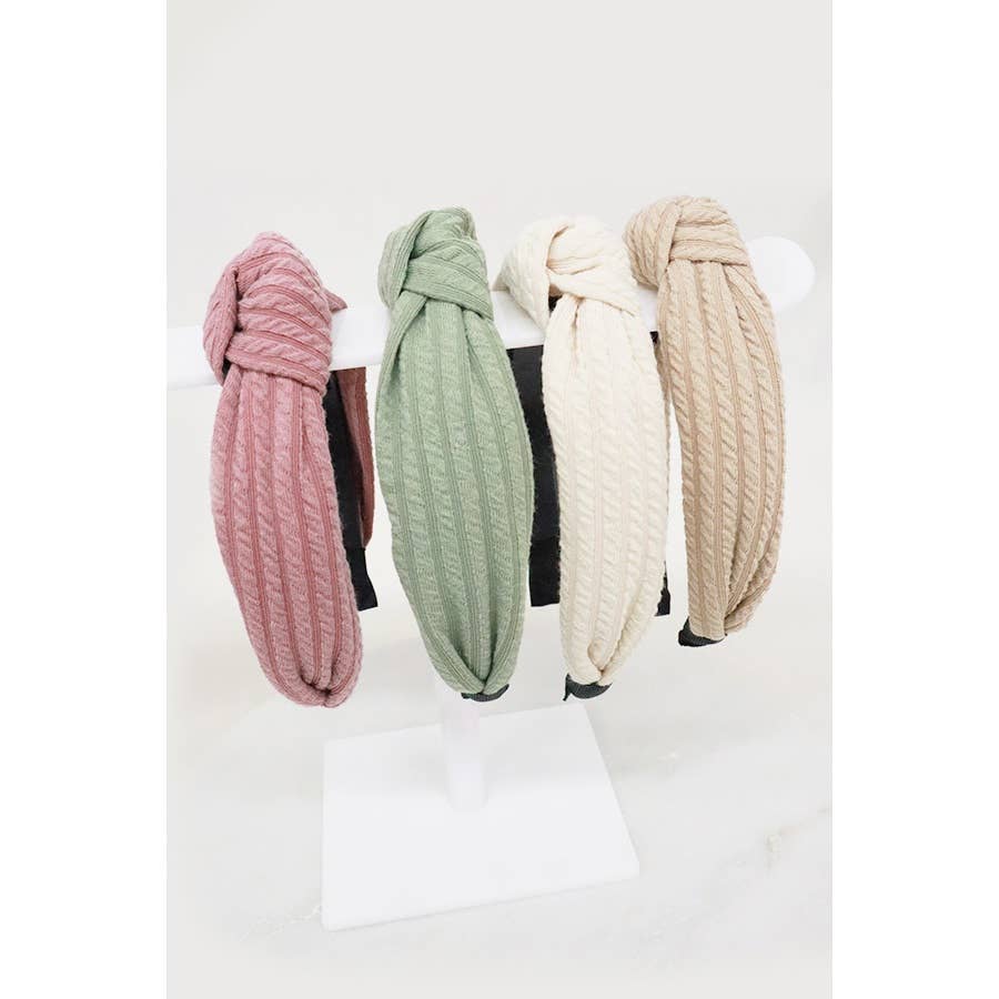 Ribbed knotted headband by Love and Repeat, featuring a textured fabric design and stylish knot detail.