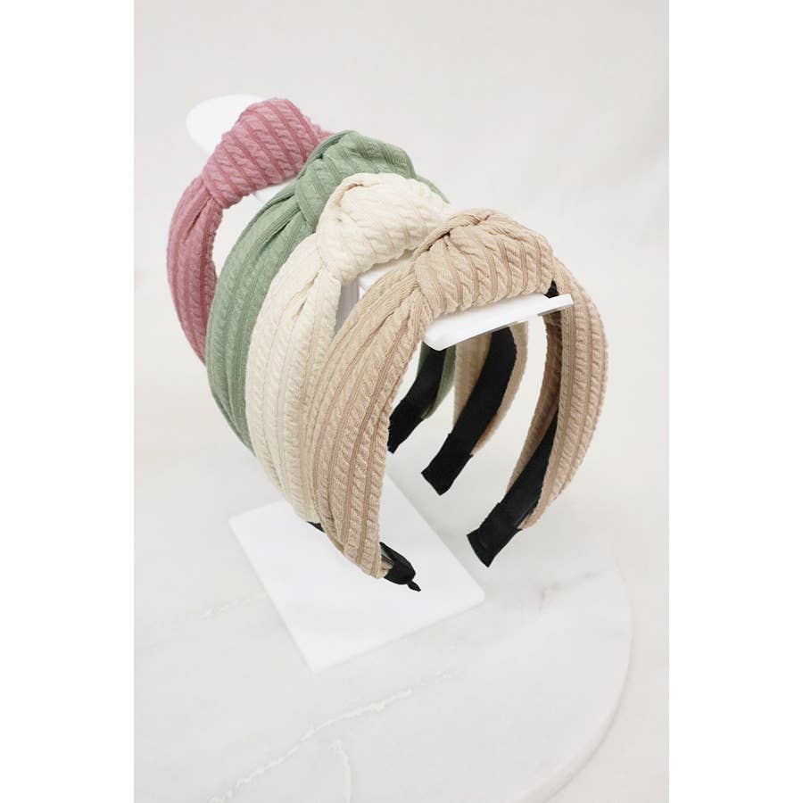 Ribbed knotted headband by Love and Repeat featuring a textured, stretchy fabric and stylish knot detail.
