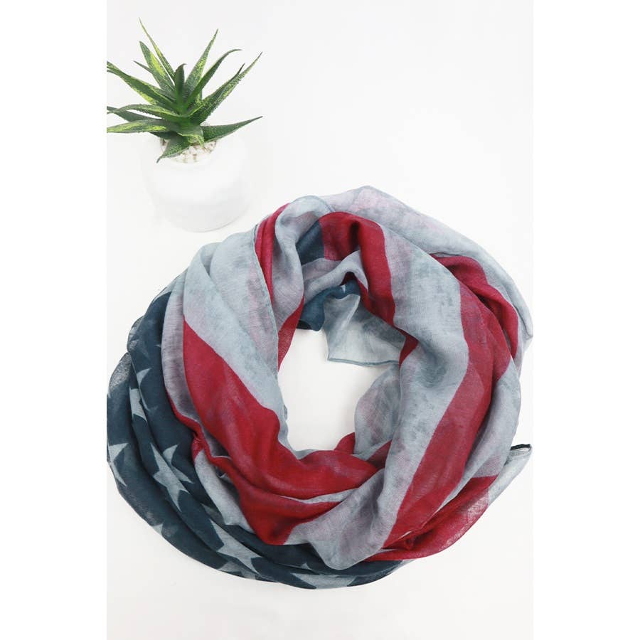 American Flag oblong scarf by Love and Repeat featuring red, white, and blue stripes with stars on lightweight fabric.