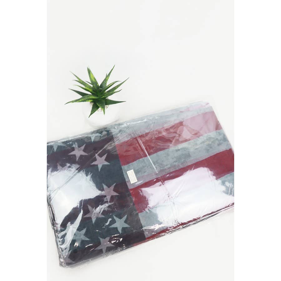 American flag oblong scarf by Love and Repeat featuring red, white, and blue stripes with star patterns on lightweight fabric.
