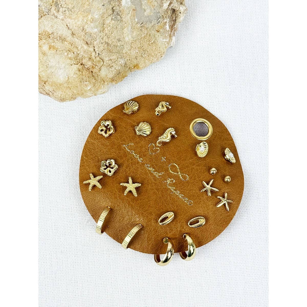 Love and Repeat beach theme earrings featuring seashell and starfish designs, perfect for ocean-inspired fashion accessories.