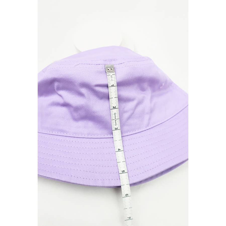 Love and Repeat hot summer bucket hat with wide brim and casual style, shown in neutral fabric on a model.