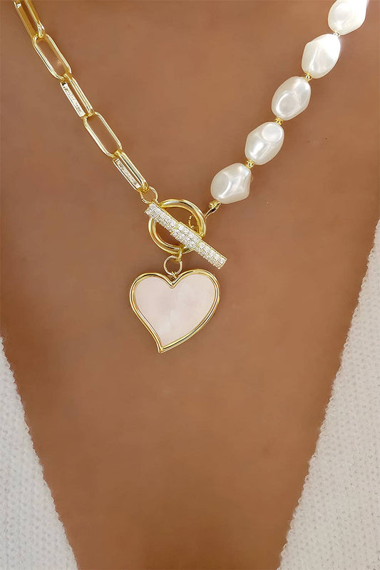 Gold heart-shaped pendant necklace with rhinestone accents and pearl chain, featuring a delicate and elegant jewelry design by Lovesoft.