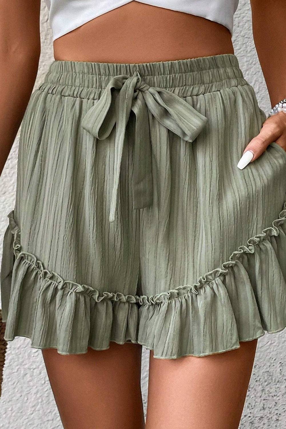 Laurel green textured tie waist shorts with ruffle hem and lightweight fabric, stylish for casual summer wear by Lovesoft.