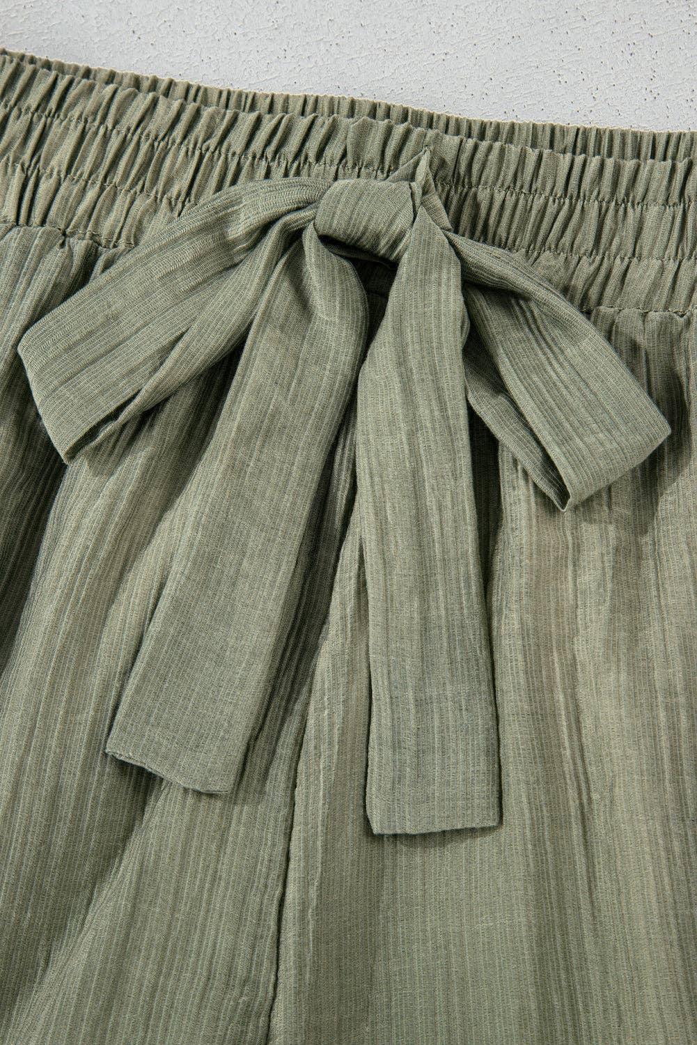 Laurel green textured tie waist shorts with ruffle hem from Lovesoft, showcasing their stylish design and comfortable fit.