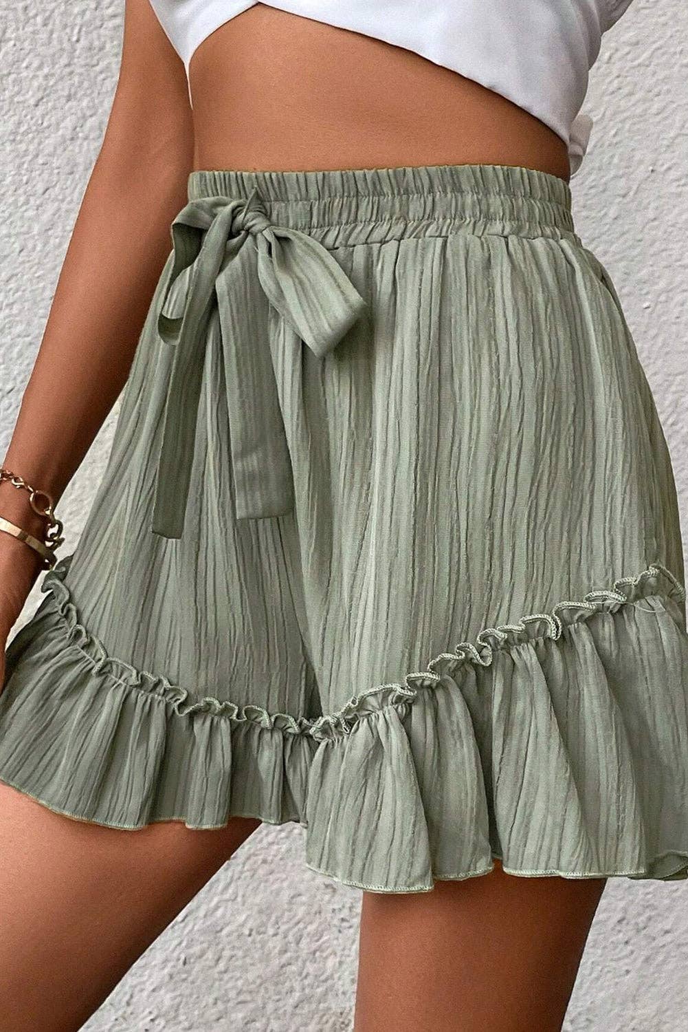 Laurel green textured tie waist ruffle hem shorts by Lovesoft, featuring a flattering silhouette and stylish ruffle detail.