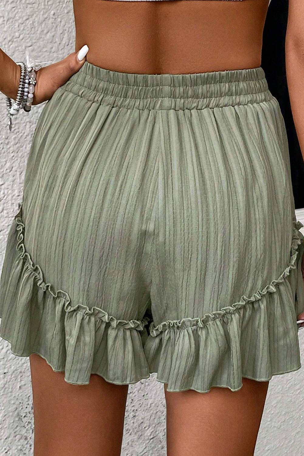 Laurel green textured tie waist ruffle hem shorts by Lovesoft, featuring a comfortable fit and stylish ruffle detail.