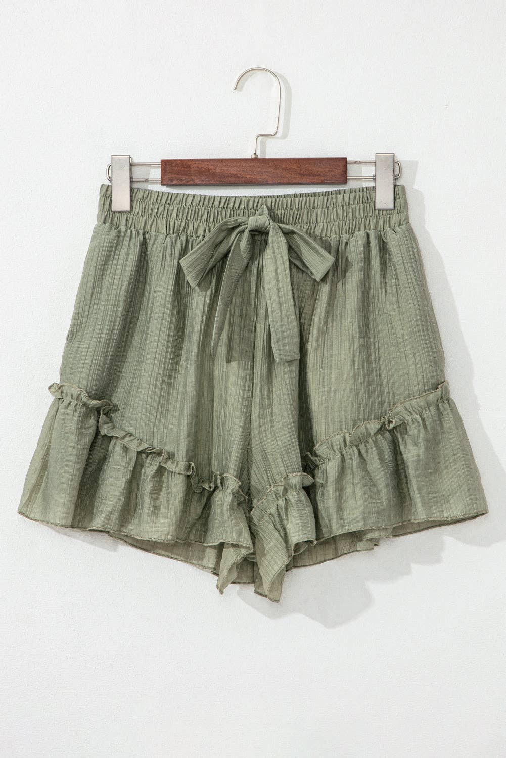 Laurel green textured tie waist shorts with ruffle hem from Lovesoft, featuring a relaxed fit and stylish design.