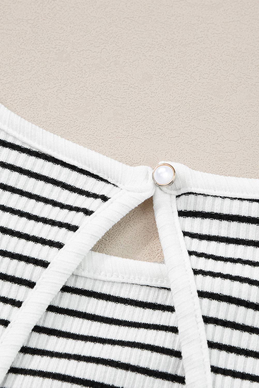 Black striped tank top by Lovesoft, featuring a sleeveless design with bold horizontal stripes on soft fabric.