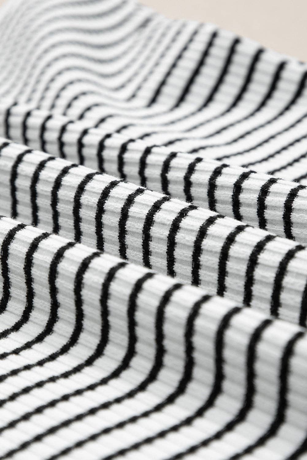Black striped tank top by Lovesoft, featuring a sleeveless design and casual fit, shown on a plain background.