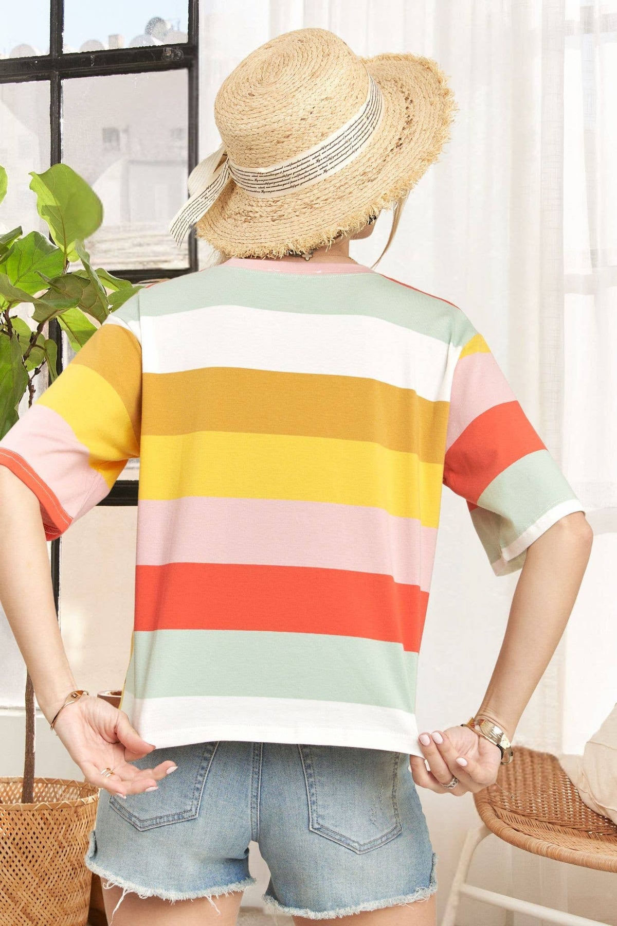 Madelyn multi-color stripe cotton top displayed on a hanger with vibrant vertical stripes and a casual fit.