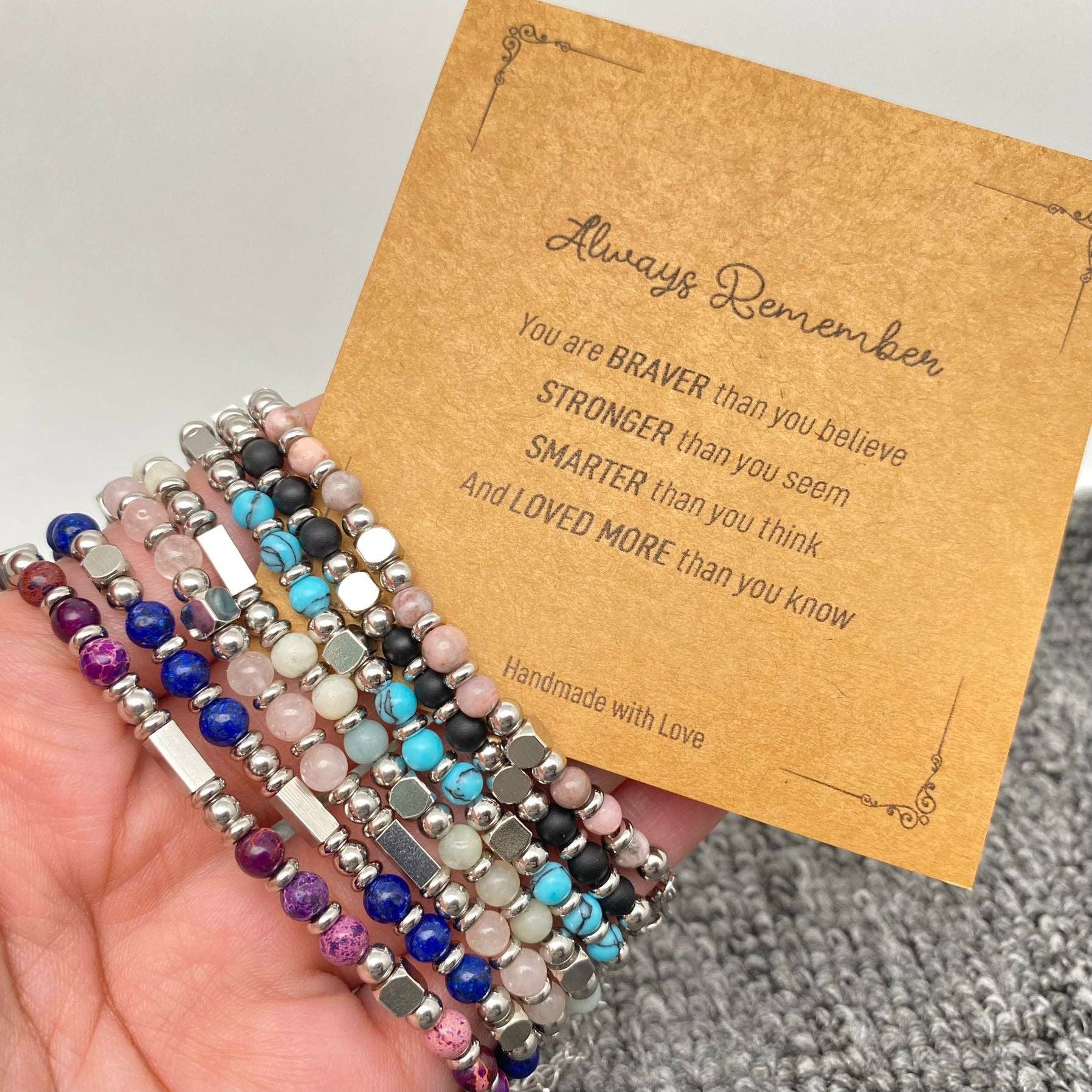 Stone and stainless steel bead bracelet with blessing card, featuring polished beads and a sleek clasp.