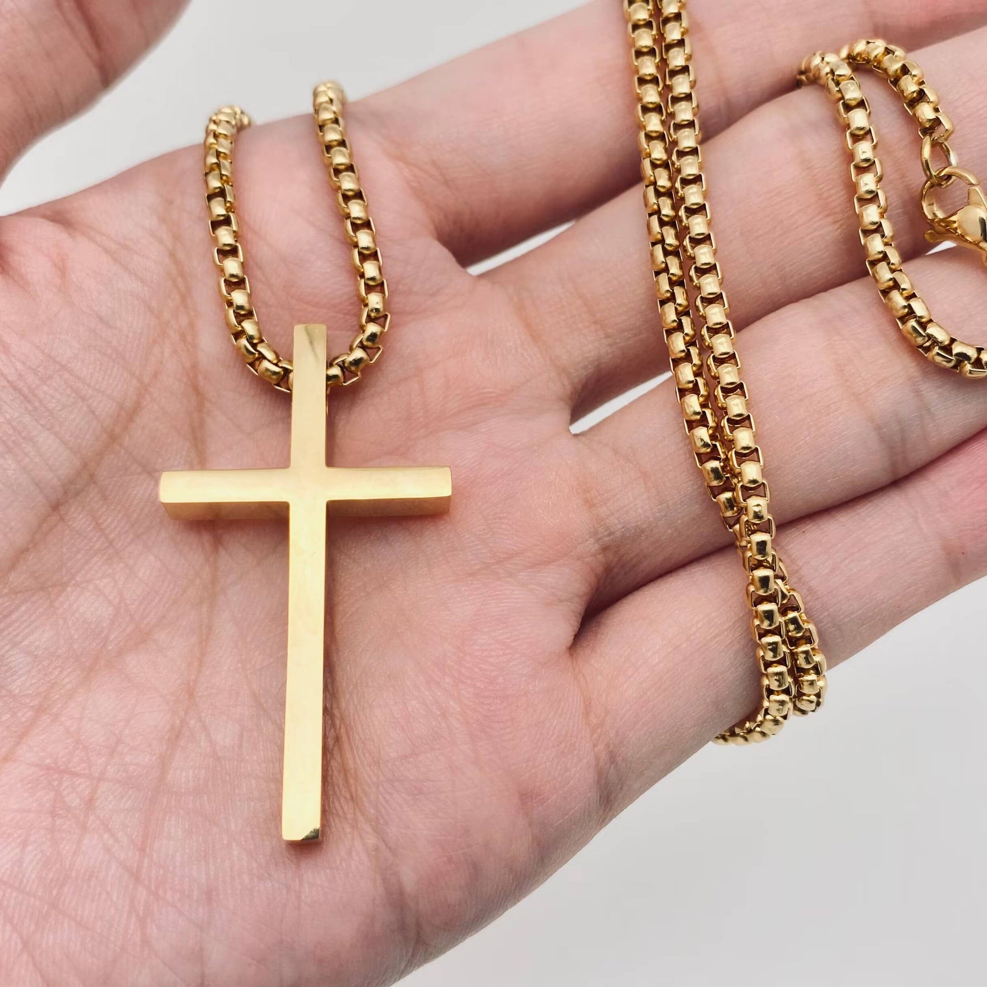 Glossy black stainless steel pendant necklace by Mio Queena featuring a sleek cross design.