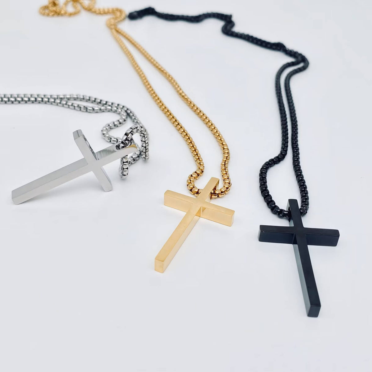 Glossy cross stainless steel pendant necklace in gold by Mio Queena, featuring a sleek, polished finish and modern design.