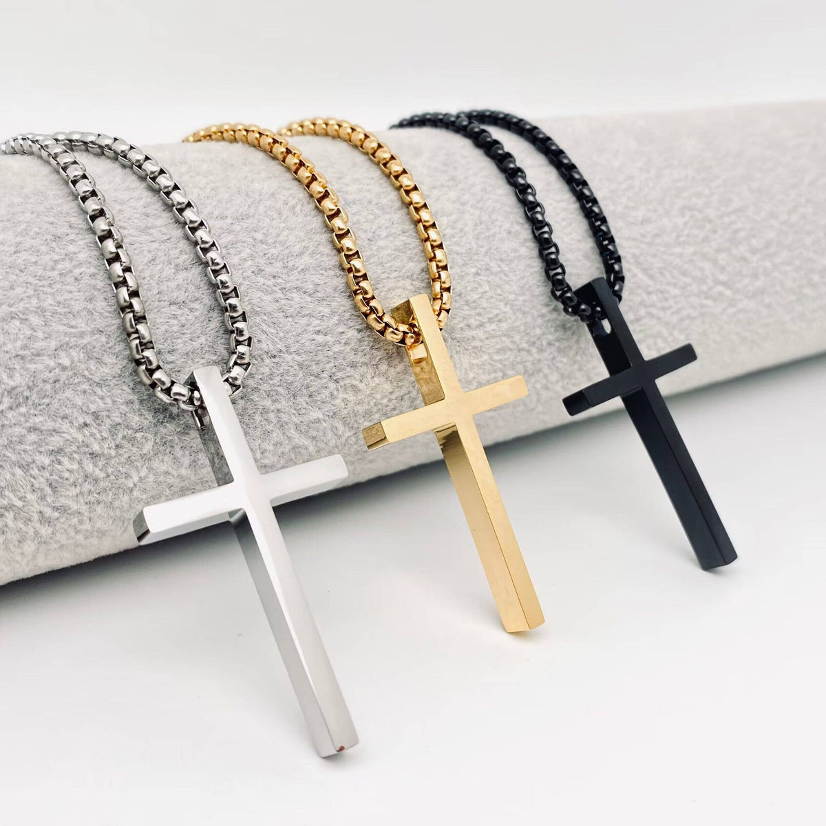 Glossy cross stainless steel pendant necklace by Mio Queena featuring a sleek steel-colored cross design.