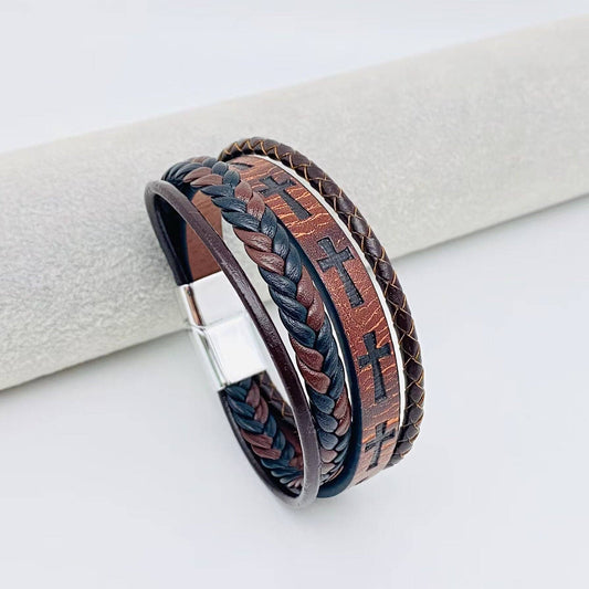 Handmade leather cross men's bracelet with magnetic buckle by Mio Queena, featuring a brown leather strap and detailed cross charm.