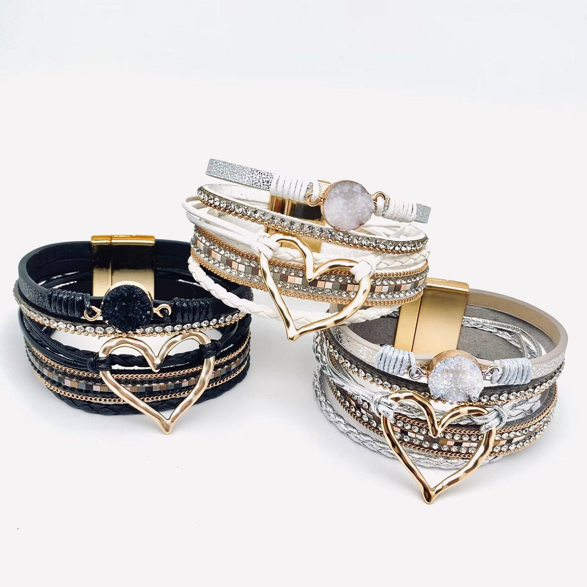 Silver Mio Queena multi-layer heart charm bangle bracelet with layered heart designs on a sleek silver band.