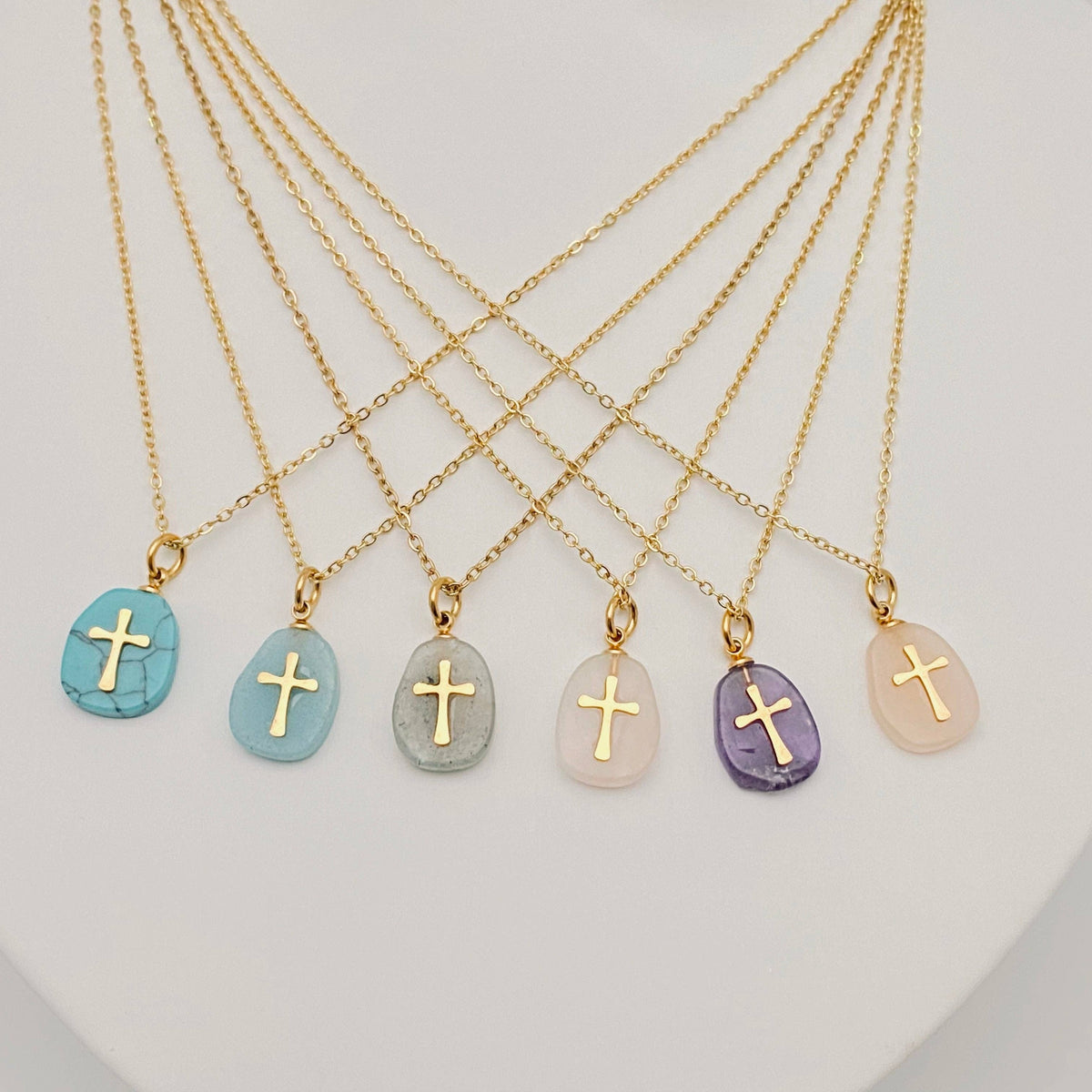 Natural stone stainless steel cross pendant necklace by Mio Queena featuring a white stone design on a sleek chain.