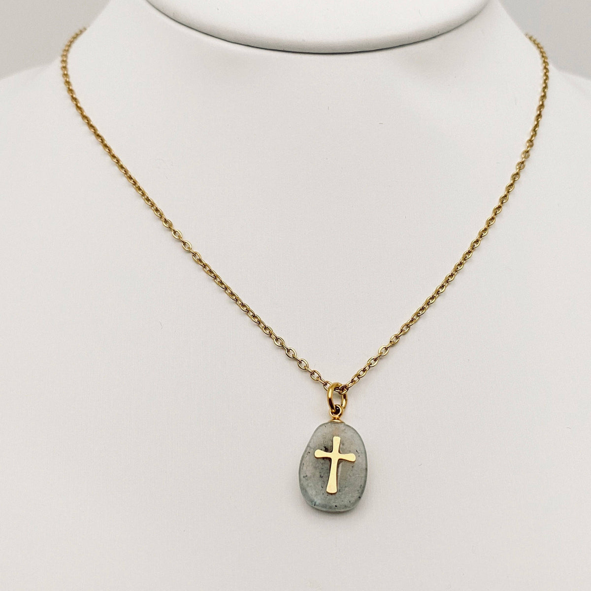 Natural stone stainless steel cross pendant necklace by Mio Queena featuring a white stone design and sleek metal chain.
