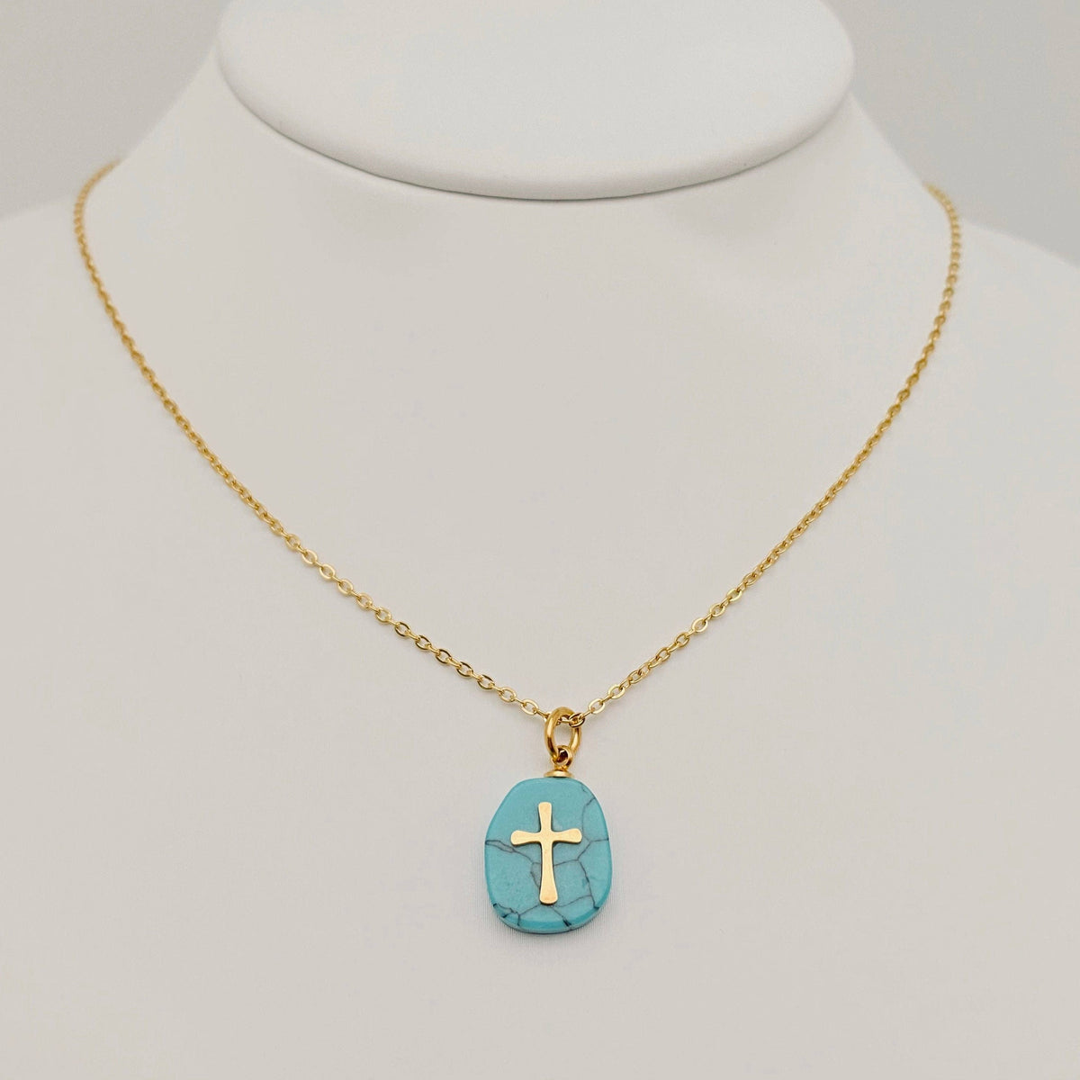 Natural turquoise blue stone stainless steel cross pendant necklace by Mio Queena, showcasing a detailed cross design on durable metal.