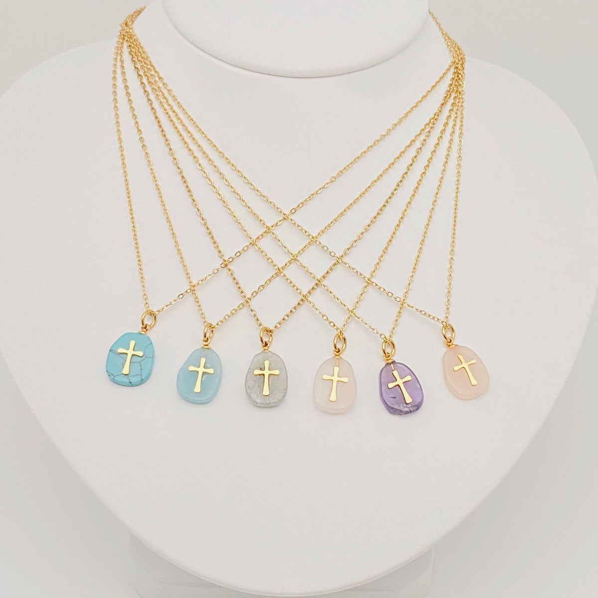 Turquoise blue natural stone stainless steel cross pendant necklace by Mio Queena, showcasing a detailed cross design on a sleek chain.