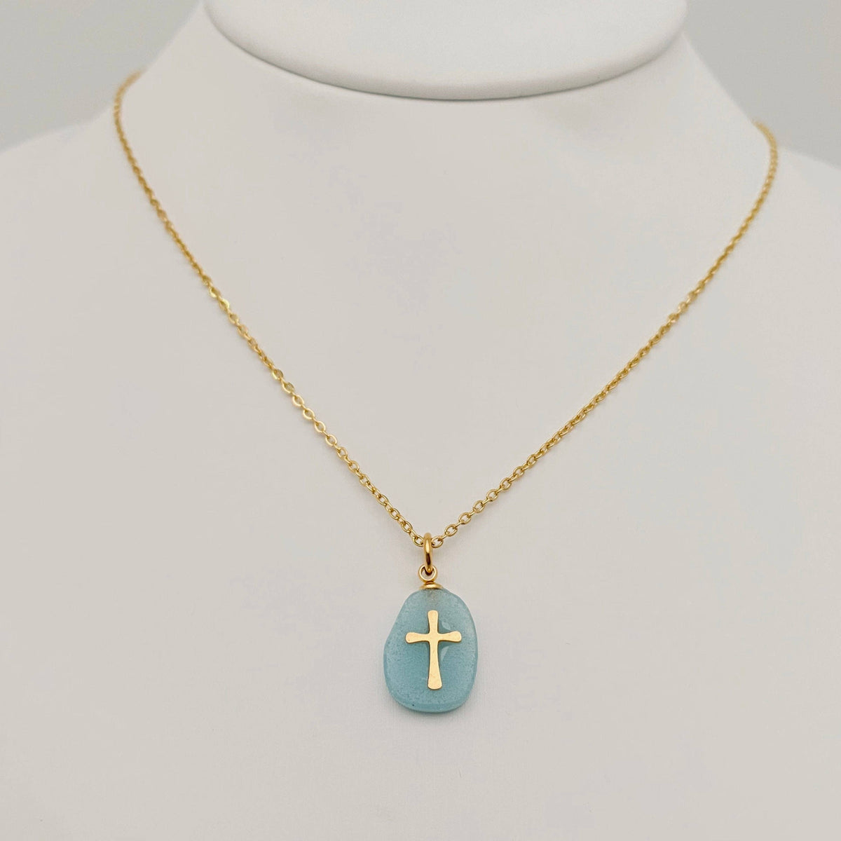 Green natural stone stainless steel cross pendant necklace by Mio Queena, featuring a polished cross design with a green stone accent.