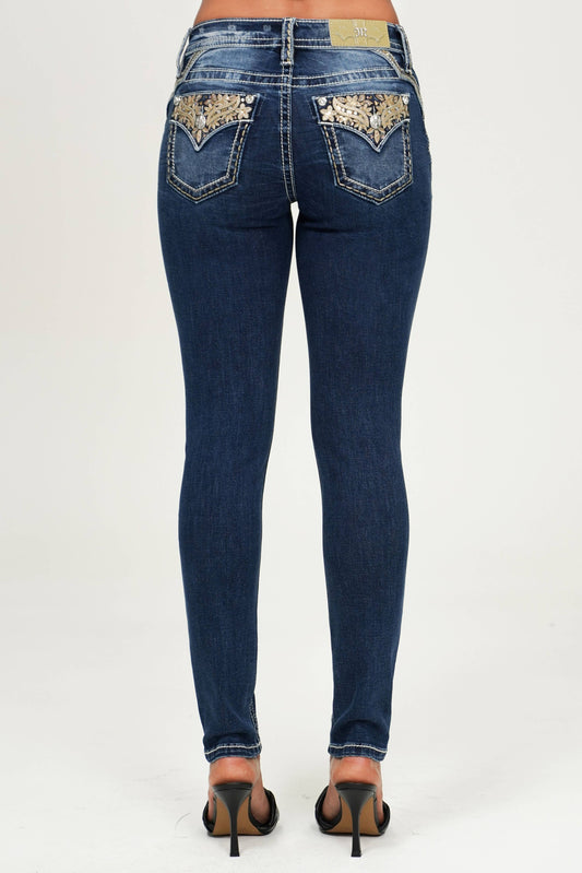 Miss Me mid-rise skinny jeans in denim, showing the fitted silhouette and classic five-pocket design.