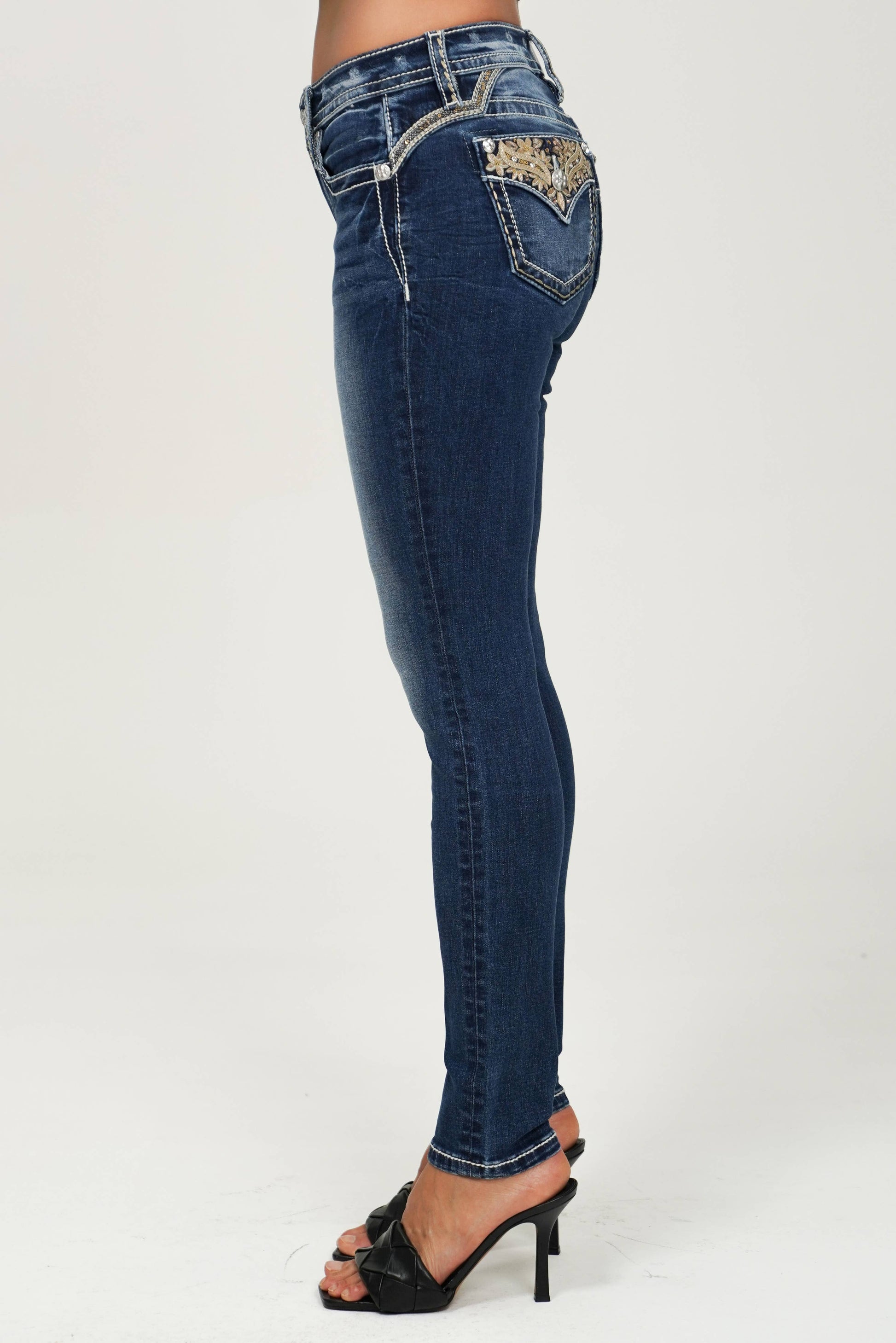 Miss Me mid-rise skinny jeans in a classic denim wash, featuring a fitted silhouette and subtle distressing.