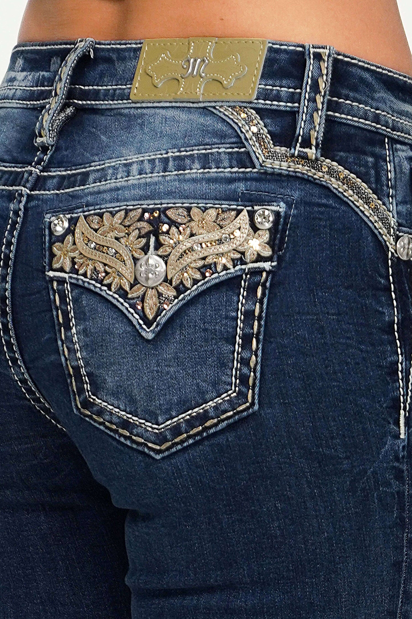 Miss Me mid-rise skinny jeans in dark wash with subtle fading and classic five-pocket design, styled for a modern, fitted look.